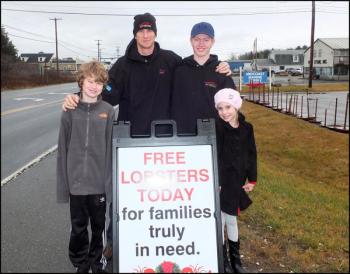Left to right Nadia Cook-Ames, Noah Ames, Jack Wadsworth and Noah Ames Jr. as they set up and get reat to start handing out lobsters in Thomaston on Christmas Eve.