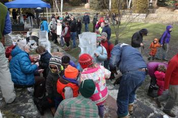 The Riley School kids work on their ice sculpture Saturday. (Photo by Holly S. Edwards)