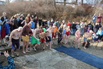 The polar plungers take off at the head of Camden Harbor. (Photo by Holly S. Edwards)