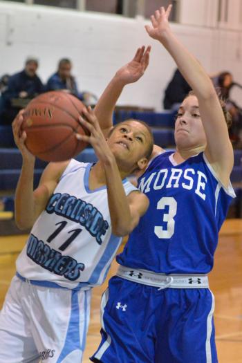 Oceanside freshman Hope Butler gets fouled going to the basket by Morse’s Maddy Mitchell in the JV game. Oceanside won the game 40-37. (Photo by Ron Hawkes)
