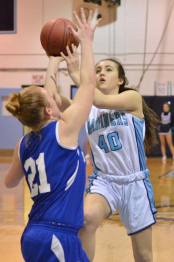 Oceanside’s Gabby Simmons goes hard to the basket and draws the foul from Morse’s Emma Harrington. (Photo by Ron Hawkes)