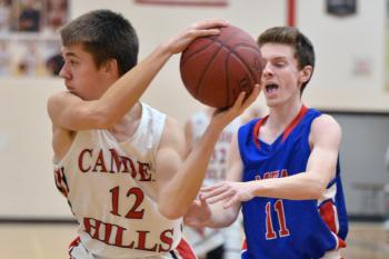 Camden’s Julian Starbird grabs a rebound and outlets it in front of Mt. Ararat’s Eric Segars. (Photo by Ron Hawkes)