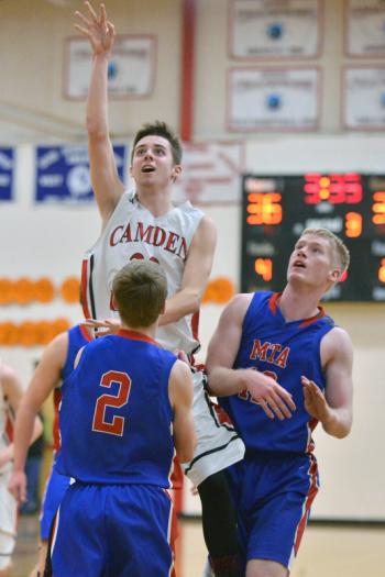 Camden’s Dalton Oakes goes up high over Mt. Ararat’s Cole Guerin as Garrett Bolduc looks on. (Photo by Ron Hawkes)