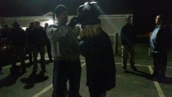 Sgt. Lance Mitchell assists a student with using protective head gear. (Photo by Sarah Shepherd)