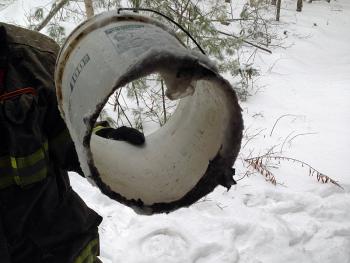 Woodstove ashes, thought to be cold, were placed into this plastic bucket, which eventually melted from the heat of the smoldering embers inside it. The bucket was also located inside the cabin on Tanglewood Road in Lincolnville, where a smoldering fire between the floor boards was called in late Saturday morning. (Photo courtesy Lincolnville Fire Department)