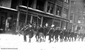 A 1920 photo of a shoveling brigade marching down Main Street. After a winter storm, men from all walks of life would gather together to help clear the nearly impassable roads. (Photo courtesy Rockland Historical Society)