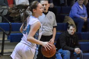 Oceanside’s Makenna Brooks clears out a rebound to set up the next shot. Oceanside beat Morse 40-37 for the win. (Photo by Ron Hawkes)