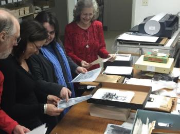 Rockport visits the Penobscot Marine Museum photographic archives in Searsport on Jan. 21 to gather images of Rockport over the centuries. in 2005, the Museum rescued the 37,000 images of Eastern Collection from Union Hall, in Rockport, and under the care of archivist Kevin Johnson, has been methodically scanning and preserving each glass-plated image for future generations. Here, Selectman Geoff Parker, Lynda Clancy, Rockport Executive Secretary Stacey Parra and Town Clerk Linda Greenlaw pore over the Edward Coffin collection of photos, which include even more images of Rockport.