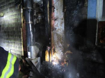 In lieu of a double-metal jacket or other kind of heat shield, aluminum foil was used to try and protect the wood wall from the heat emanating from the pipe stove during use. But the foil, also a metal, actually acted as a heat conductor and helped ignite the wood wall. (Courtesy Rockport Fire Department)