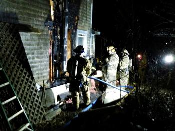 Fire heavily damaged the side of the home at 30 Winding Way in Rockport Saturday night, while Rockport firefighters worked to put it out with help from Camden, Rockland and Hope fire departments. (Photo by Sarah Shepherd)