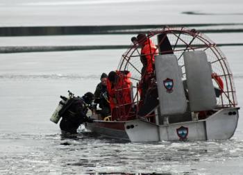 A diver slips into the lake Tuesday morning. (Photo by Holly S. Edwards)