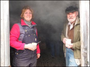 Winston Pendleton and his daughter, Wendy Harvey, without the steam as they make maple syrup at the sugar shack. (Photo by Chris Wolf)