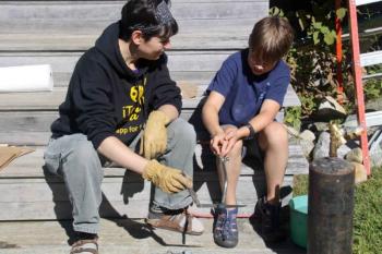 Heidi O'Donnell with her son, Matthew, heating and tempering a steel knife