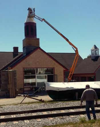 From the ground to the top of the building, a new steeple gets set into place.