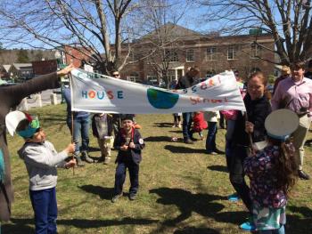 Student Max Turek and Parent Jackie Gelwix held hold a banner. (Photo courtesy Kathryn Dermott)