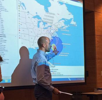 National Hurricane Center forecaster Jack Beven describes his work to the group.