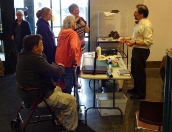 Portland Public Library Archivist Abraham Schecter gives a demonstration on book conservation at the Belfast Free Library. (photo by Erica Thoms)
