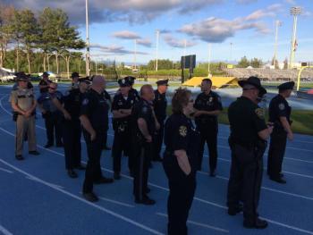 Law enforcement officers are ready to march into the stadium for the opening ceremony. (Photo by Justin Hills)