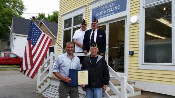 Jamie Weymouth, owner of Camden Clothesline on outer Washington Street, accepts a certificate of recognition from Frank Carr, commander of American Legion Post No. 30 in Camden. Standing in the back from left are Jeff Sukeforth, post adjutant, and Cecil E. Dennison, honor guard member. (Photo by Sarah Shepherd)