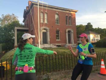 One runner’s leg ends in front of Wiscasset’s former customs house June 25, and a teammate’s leg begins, during the Rock Lobster Relay from Bar Harbor to Portland. SUSAN JOHNS/Wiscasset Newspaper