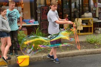 Family fun with giant bubbles during the 2013 Summer Solstice Celebration in downtown Rockland. (Photo by Ron Hawkes)