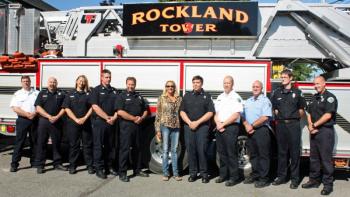 In the center from left, Rockland City Mayor Louise MacLellan-Ruf, Bill Pendleton and Rockland Fire Chief Chris Whytock pose with members of the department July 20. (Photo by Holly S. Edwards)