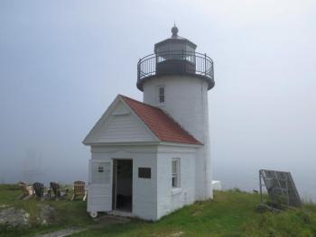 The schooner Olad, homeport Camden, passes by Curtis Island lighthouse on a foggy morning. (Photo by Bob Trapani)
