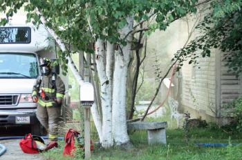 After extinguishing most of the fire, Rockport and Rockland firefighters set up a fan to push air out of the basement, where the fire originated in and/or around an electrical panel. (Photo by Holly S. Edwards)