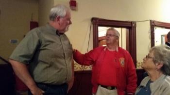 Bob Oxton, former Camden Fire Chief, and his wife Judy, spend time with retired Police Chief Mark Kelley at his retirement party July 7 at the Rockport Opera House.(Photo by Sarah Shepherd)