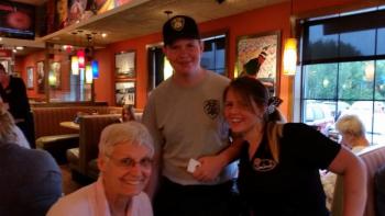 The Knox County Explorers joined the fun and served as waiters, here at the table of Debbie Green of Camden. (Photo by Sarah Shepherd)