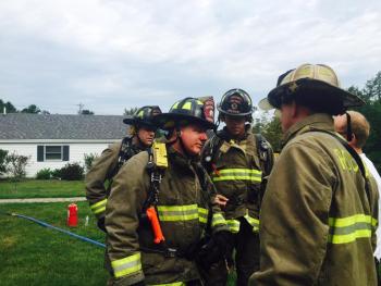 Rockport firefighters Bill Lane and Justin Ford talk with Asst. Fire Chief John Wickenden about inspection of the fire scene. (Photo by Lynda Clancy)