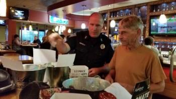 Troy Peasley, Rockland Parking Enforcement Officer and Coodinator of the event, was selling the raffle tickets for the autographed sports items from David Ortiz and Tom Brady. (Photo by Sarah Shepherd)
