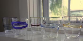 Another set of the finished drinking glasses. The newly created glasses must spend a day in the annealing kiln, where a computer maintains a consistent 960 degree temperature, allowing the molecules to settle and all the stress to come out of the glass before slowly bringing the pieces to room temperature. (Photo by Holly S. Edwards)