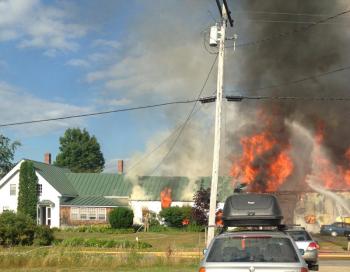Despite their efforts, the fire extended from Rick Kidson’s work storage area and woodworking studio to an el, which eventually collapsed. (Photo by Holly S. Edwards)