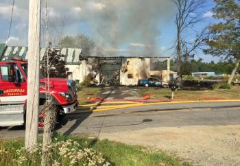 The fire was tamped down where it began, but then rekindled and began burning the wood stored inside while firefighters focused their efforts on keeping fire from extending to the main house. (Photo by Holly S. Edwards)