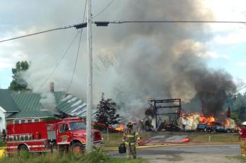 Fire began to the right, at the south end of this old farmhouse on Lincolnville Road in Belfast, where the 14th BelTek Festival was on its second and final near-24-hour day of techno dance music outdoors on the farm’s 14 acres. (Photo by Holly S. Edwards)