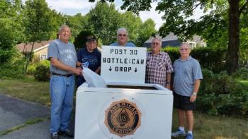 Frank Carr, American Legion Post 30 Commander, Kip Stinson, member, Jeff Sukeforth, Adjutant, Cecil Dennison, Service Officer and John Hyssong, member, stand with the organization’s new returnable collection box. Proceeds from the recycling program will benefit the Legion’s community projects. (Photo by Sarah Shepherd)