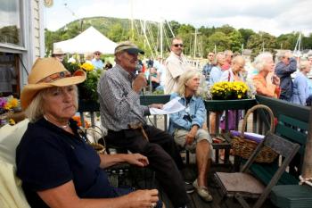 Capt. Jim Sharp entertains the crowd and narrates the history of each schooner as it makes its way into Camden Harbor Friday afternoon, as well as information about what they did and why and for whom. (Photo by Holly S. Edwards)