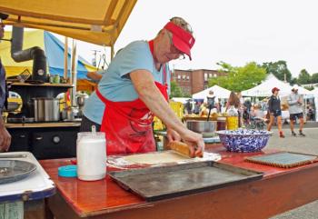 Longtime schooner cook Bridget Qualey of Camden will be baking homemade apple pies, to sample, in her wood-fired oven all weekend on the public landing. (Photo by Holly S. Edwards)