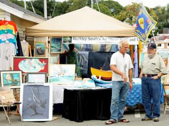 Artist Buckley Smith, left, will be displaying his nautical art and probably painting something during the weekend as well. (Photo by Holly S. Edwards)