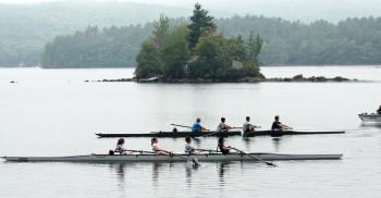 Rowers pass by islands in Megunticook Lake, which have exposed rock ledges and rocky outcroppings usually submerged at this time of year. (Photo by Holly S. Edwards)
