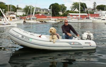 Capt. Rick Bates and one of his two Labradoodles, a fine boat dog if ever there was one. (Photo by Holly S. Edwards)