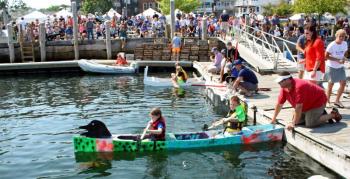 Team Pesky Pirate work on their balance and ballast before the start of the Build-a-Boat race. (Photo by Holly S. Edwards)