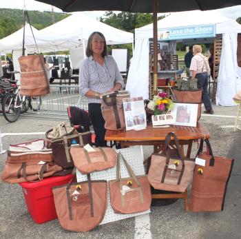Lynne McHenry displays and sells bags made from recycled sails.
