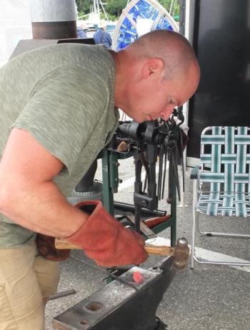 Jeff Libby works on a piece from the forge at the Blackwood Forge booth.