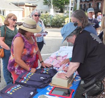 Volunteers sell T-shirts.