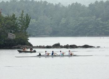 A Megunticook Rowers team passes by exposed rocks in Megunticook Lake on Sept. 19. The lake is about 2 feet lower than it normally is this time of year, due to a lack of rain and leaks at Seabright Dam, which helps control and maintain the river level as it passes through town and empties into the head of Camden Harbor.. (Photo by Holly S. Edwards)
