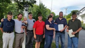 Matt Barter, owner of Glen Cove Inn and Suites, displays a certificate of recognition from the American Legion Post 30 in Camden. Pictured from left are Geoff Chapman, Legion member, Owen Casas, chaplain, and his son Cannon, Norm Carver, historian, John Hyssong, Legion member, Rich and Laura Bosio, Glen Cove Inn and Suites managers, Barter, and Frank Carr, Legion Commander. (Photo by Sarah Shepherd)