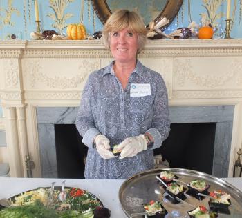 Linda Butler serves up smoked salmon prepared by the museum.