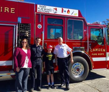 The fifth-grade winner of the Camden Fire Department’s fire safety logo art program is Ryan Andersen, a student at CRMS. Pictured with Andersen is Jaime Stone, principal at CRMS, firefighter Matt Heath and Camden Fire Chief Chris Farley. (Photo courtesy of Jaime Stone)
